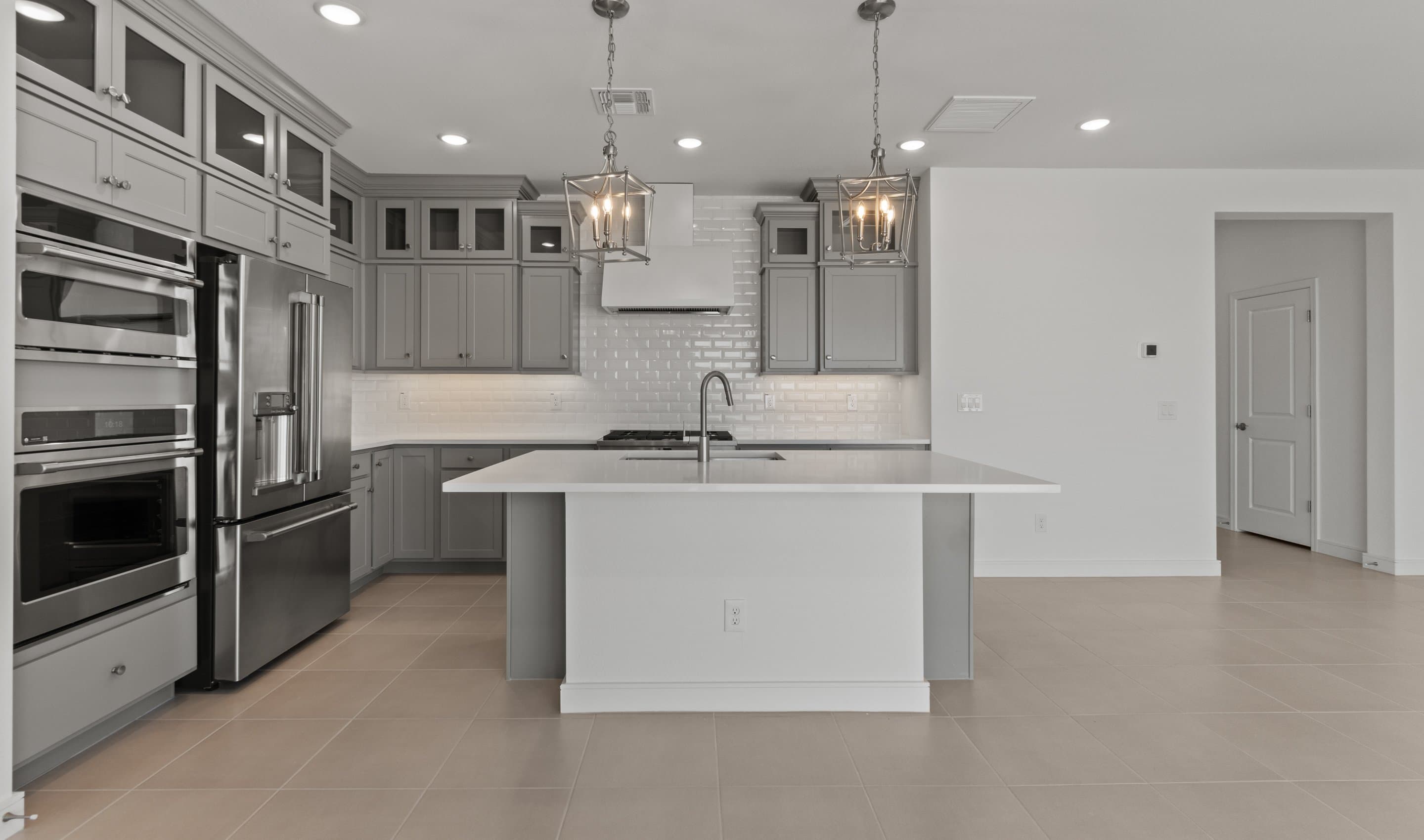 Kitchen with stacked glass-front upper cabinets