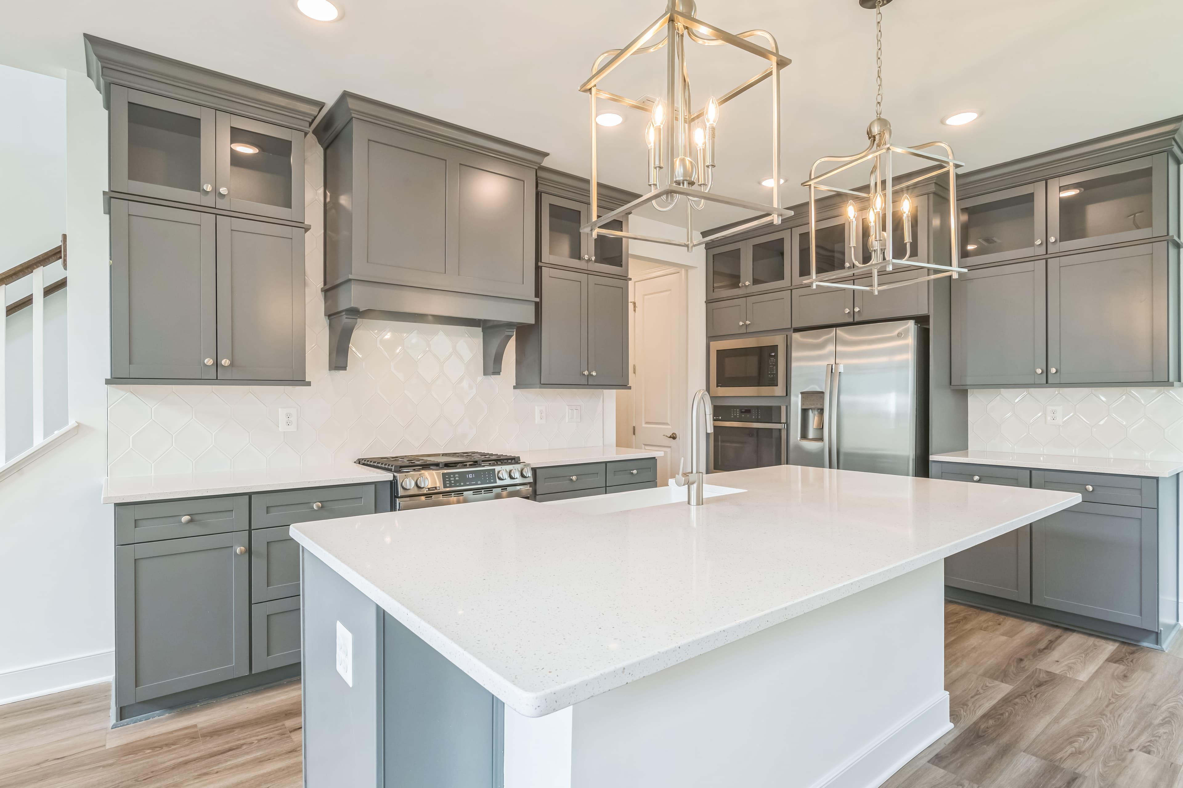 Kitchen with stacked glass-front upper cabinets