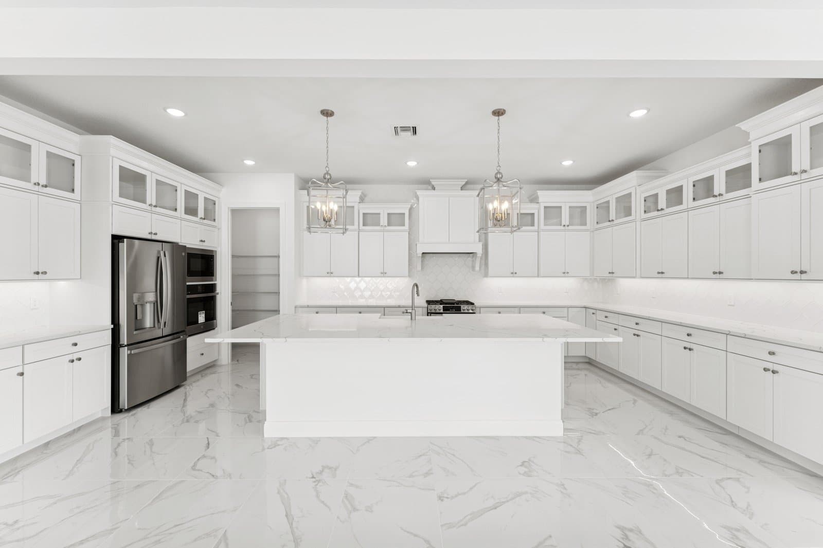 Kitchen with Brellin White cabinetry & upper glass cabients