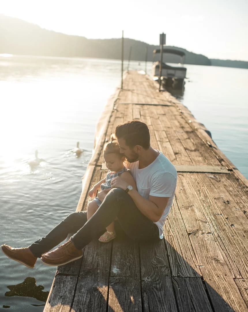 Man with Daughter on dock at Lake