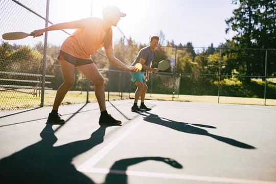 Man and Woman Playing Pickleball