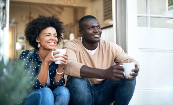 Couple Sitting on Steps with Coffee