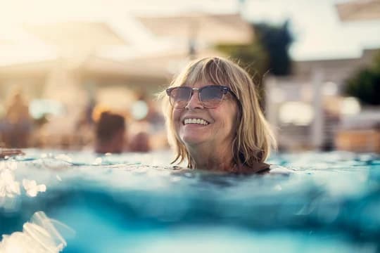 Older Woman Swimming in Pool