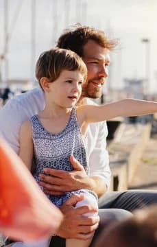 Boy and Father Sitting on the Harbor USP Crop