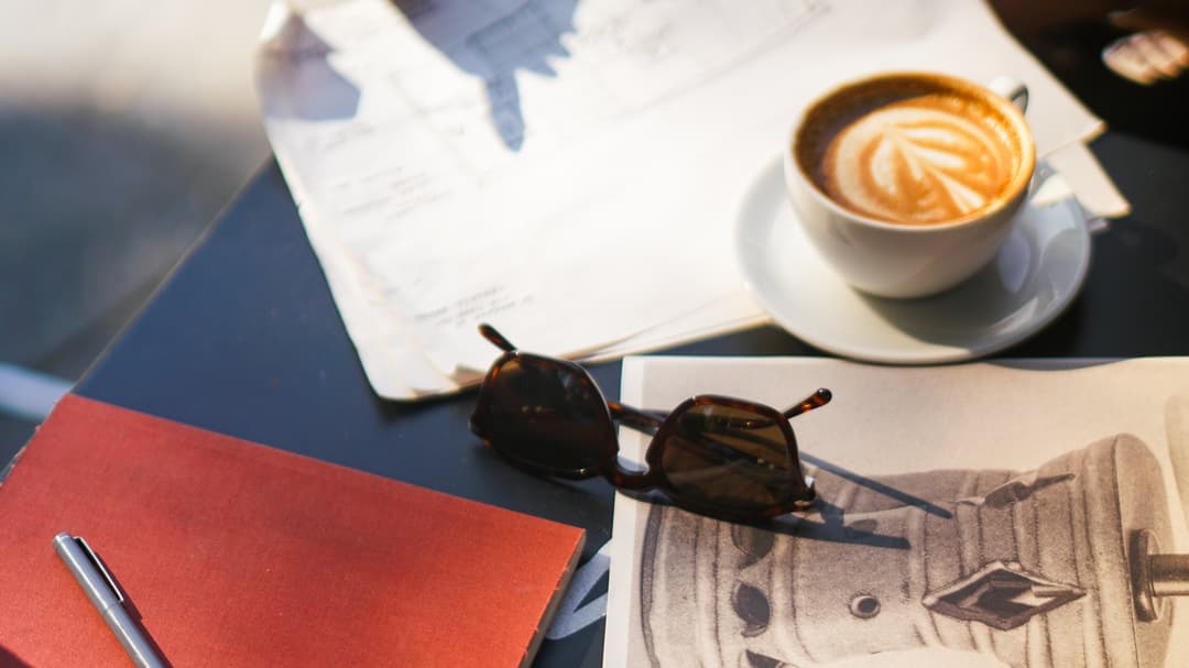 Interiors Team Working at Cafe Kitsune In West Village with Red Notebook