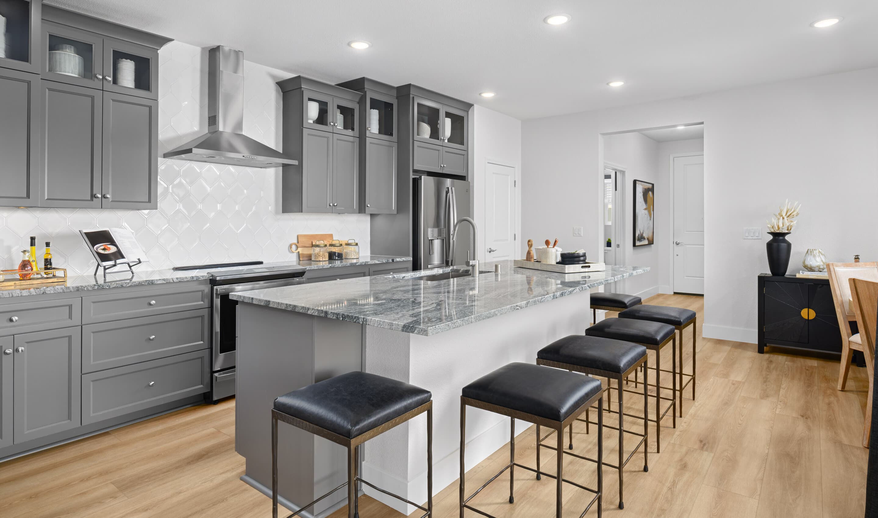 Kitchen with glass upper cabinets and stainless steel hood