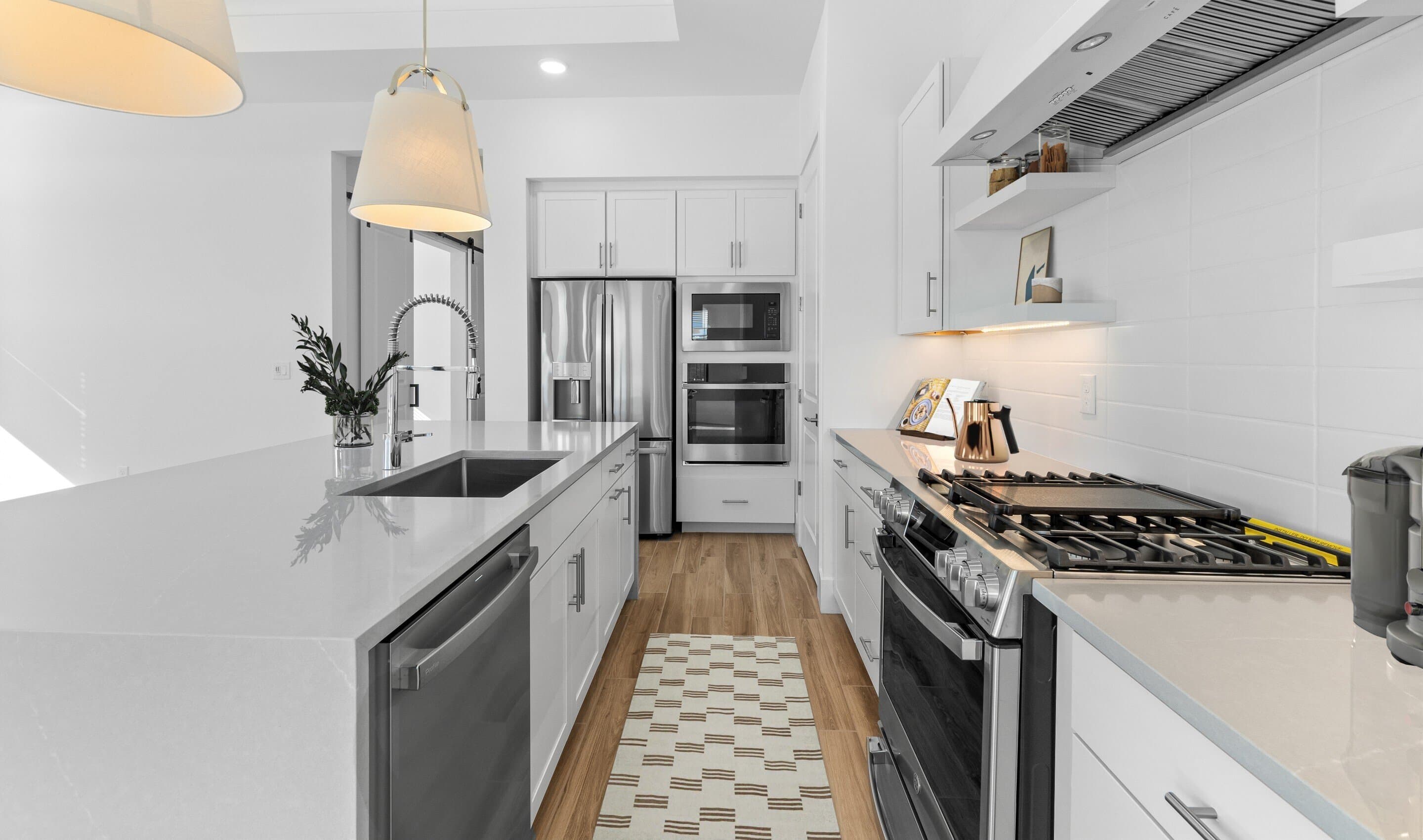Kitchen with waterfall island and stainless steel appliances