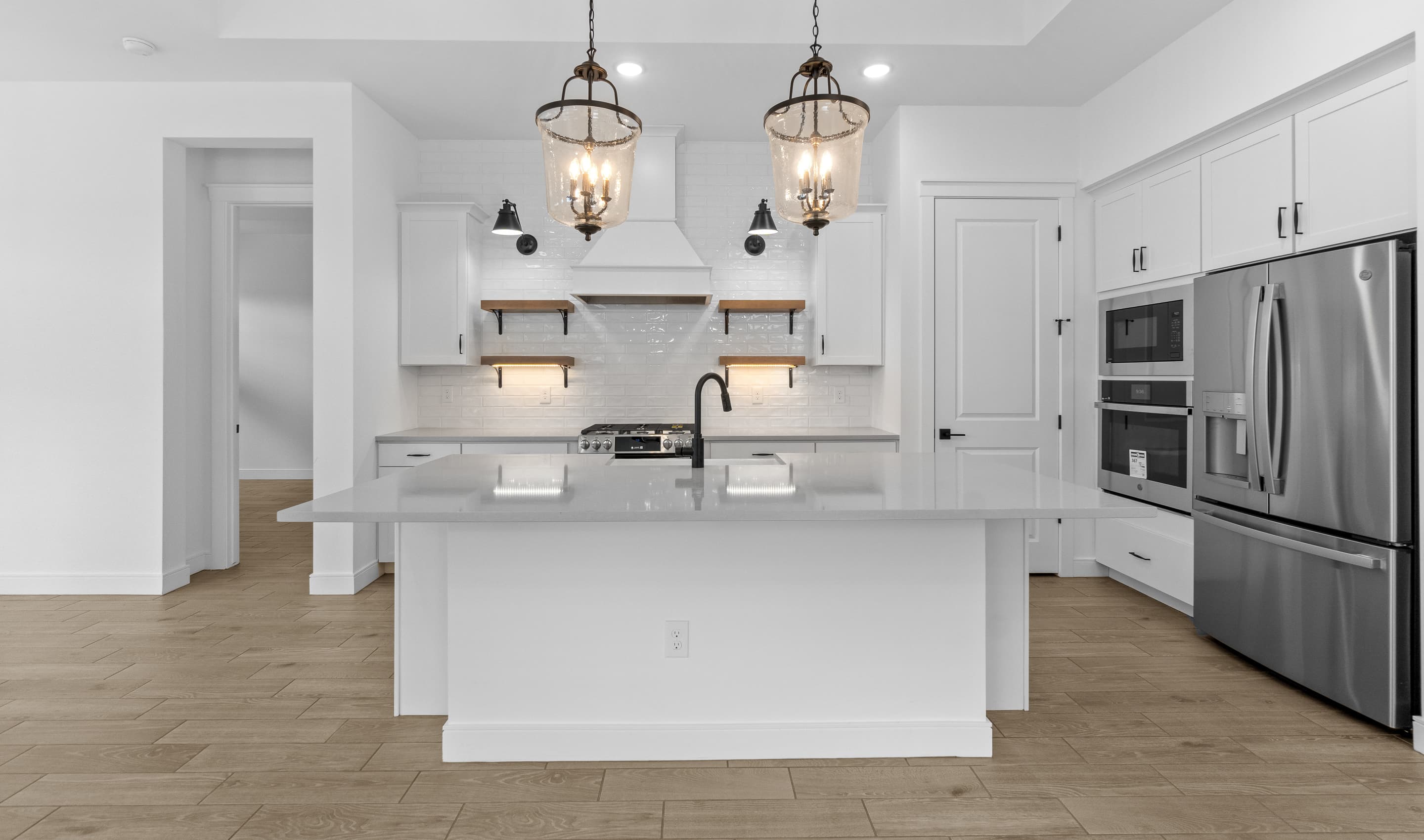 Kitchen with pendant lights & white cabinets