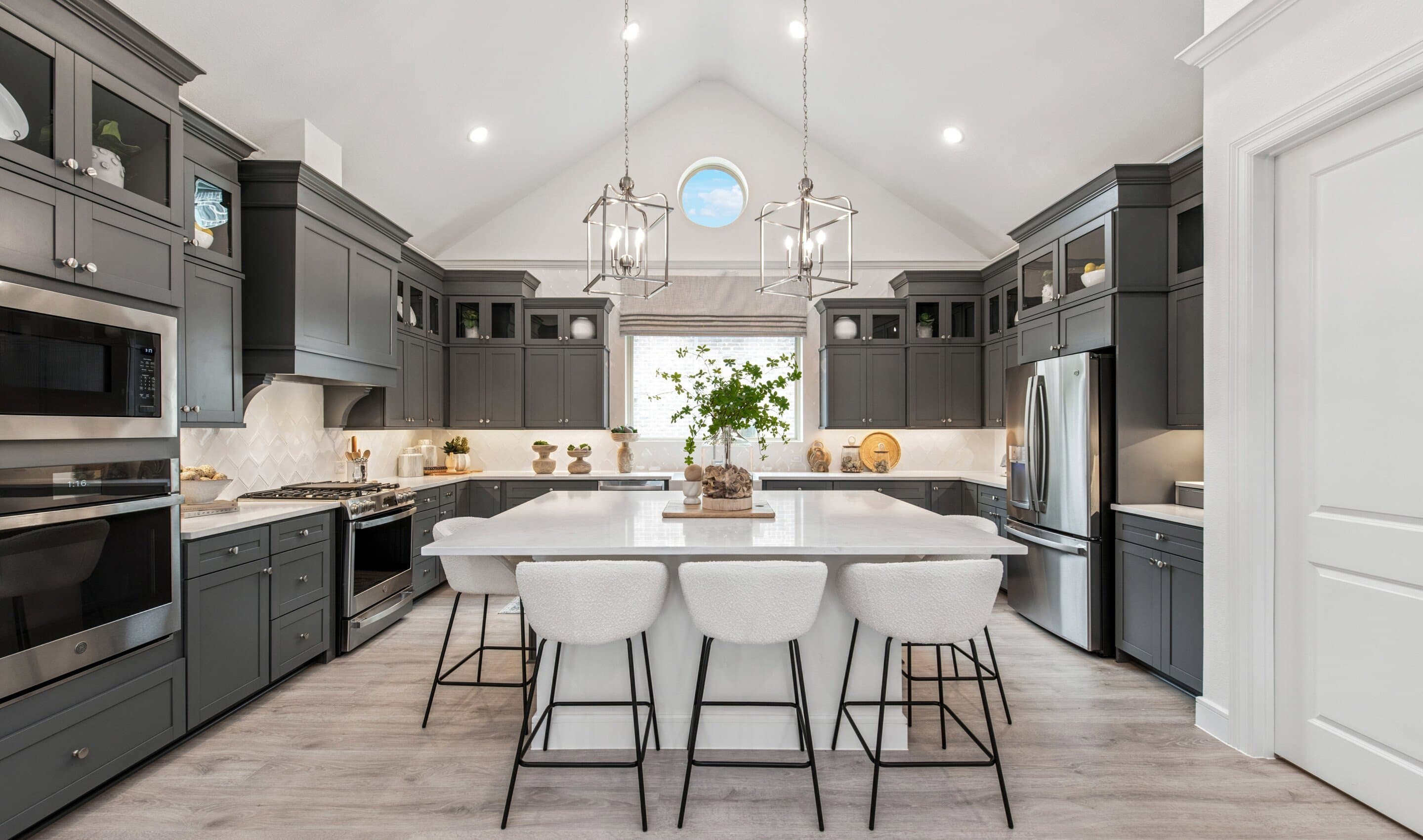 Kitchen with stunning stacked cabinetry with glass-front uppers